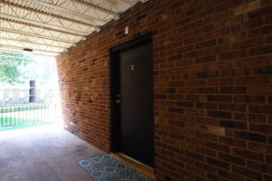 Brick building and cement floor, Door E