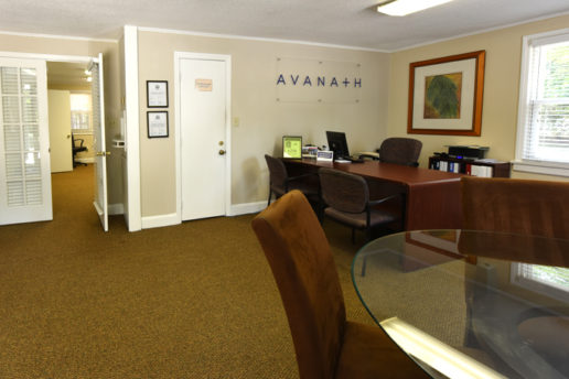 Leasing office with desks and chairs, Avanath logo on wall